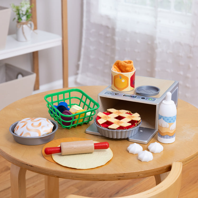 A playroom scene with The Melissa & Doug Make and Bake Pies Pretend Play Food Set And Wooden Oven With Squishy Dough for Ages 3+