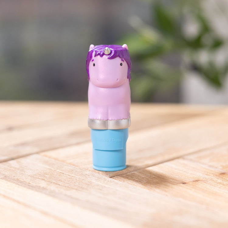 A playroom scene with The Melissa & Doug Sticker WOW!™ 24-Page Activity Pad and Sticker Stamper, 300 Stickers, Arts and Crafts Fidget Toy Collectible Character – Sprinkles the Purple Unicorn