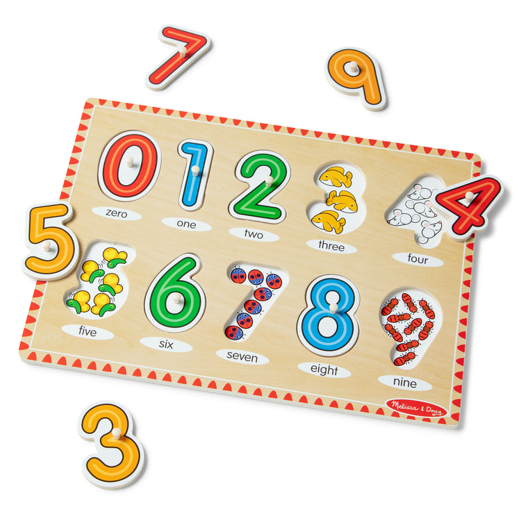 The loose pieces of The Melissa & Doug Lift & See Numbers Wooden Peg Puzzle - 10 Pieces