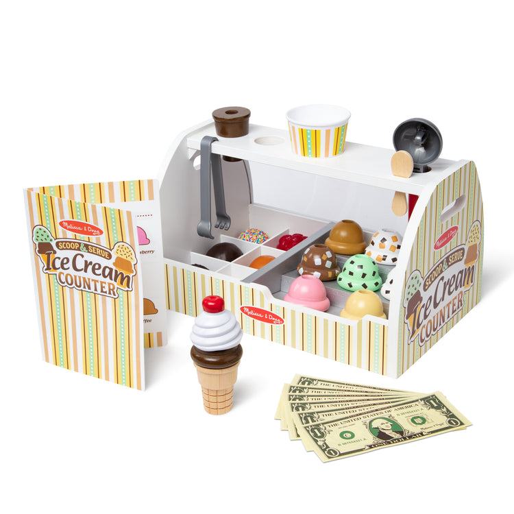 The loose pieces of The Melissa & Doug Wooden Scoop and Serve Ice Cream Counter With Play Food and Accessories (28 Pcs) 