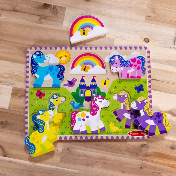 A playroom scene with The Melissa & Doug Wooden 6-Piece Unicorn and Rainbow Chunky Puzzle for Toddler Boys and Girls 2+