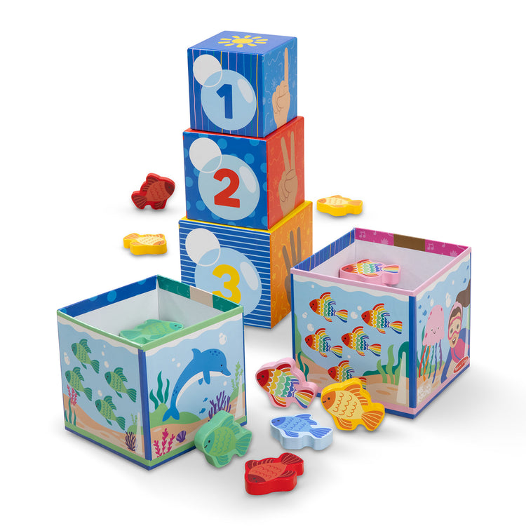 The loose pieces of The Melissa & Doug® Ms. Rachel™ Sort and Count Nesting and Stacking Blocks with Wooden Fish Preschool Learning Toy for Boys, Girls